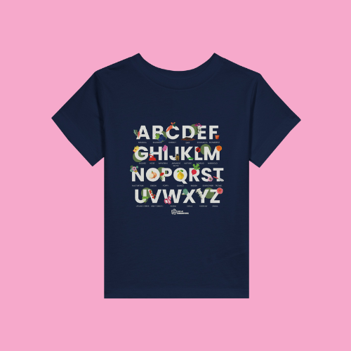 Little Gardeners Navy ABC Toddler T-Shirt featuring a colorful garden-themed ABC illustration on a soft cotton tee on a pink background