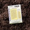 Back of a Basil seed packet features growing information and culinary uses, highlighting its rich aroma and versatility in cooking. Essential details like maturity time and seed count are clearly displayed on a dirt garden bed.