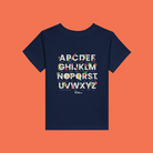 Little Gardeners Navy ABC Toddler T-Shirt featuring a colorful garden-themed ABC illustration on a soft cotton tee on an orange background.