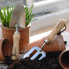 Stainless Steel Garden Trowel with Rubberwood Handle in dirt